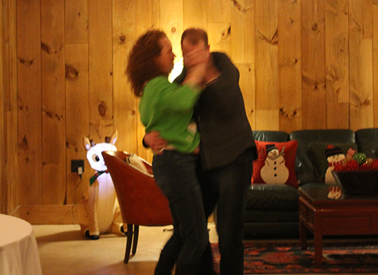 Photo of two people dancing at a Holiday party