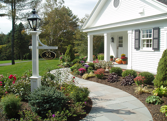 Picture of entrance to home with stone walkway and sign